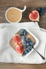 Porridge with figs and blueberries in square bowl — Stock Photo