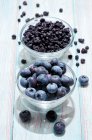 Blueberries, fresh and dried in glass bowls — Stock Photo
