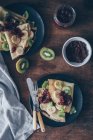 Crepes with chocolate spread, jam and fruits — Stock Photo
