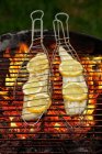 Zander fillets in fish baskets on a grill — Stock Photo