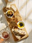 Bread with cheese and vegetables on wooden table — Stock Photo