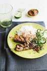 Tempeh and pork skewers with rice served on plate — Stock Photo