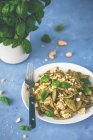 Spinach pasta with pesto, tofu and nuts — Stock Photo