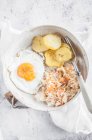 Fried potatoes, fried egg, salad with carrot and apple — Stock Photo