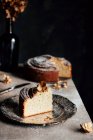 Banana bread, sliced on a table against a black background — Stock Photo