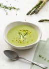 Creamed asparagus soup on white — Stock Photo