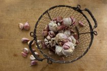 Garlic in a wire basket — Stock Photo