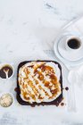 Coffee cake with whipped cream and caramel sauce — Stock Photo