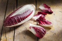 Long red chicory on rustic wooden table — Stock Photo