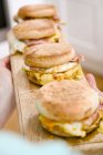 Egg, cheese and bacon muffins on wooden board — Stock Photo