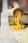 Making pasta in pasta machine — Stock Photo