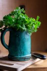 Fresh parsley in a vintage measuring jug — Stock Photo