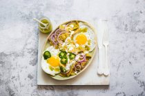 Fried eggs with bacon and cheese on a white plate. top view. free space for your text. — Stock Photo