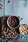 Hazelnuts, shelled and unshelled in two bowls — Stock Photo