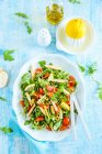 Fresh chicken salad with rocket olives cherry tomatoes and lemon — Stock Photo