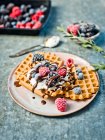 Waffles with cream and frozen berries — Stock Photo