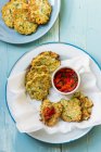 Halloumi and zucchini fritters with red pepper and parsley salsa — Stock Photo