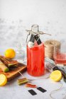 Red wine with lemon and rosemary on a wooden background. selective focus. — Stock Photo