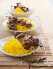 Lamb skewers on saffron rice — Stock Photo