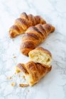 Puff pastry croissants on a marble table — Stock Photo
