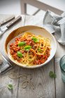 Spaghetti with bolognese sauce, parmesan cheese and basil — Stock Photo