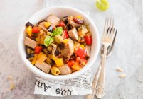 Eggplant caponata and peppers with olives raisins pine nuts and fresh swordfish — Photo de stock
