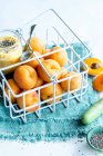Wire basket of fresh apricots and chia seeds apricot dessert in jar — Stock Photo
