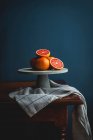 Pink grapefruits on a cake stand — Stock Photo