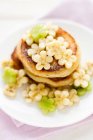 Coconut pancakes with flower shaped banana and kiwi slices — Stock Photo