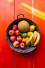 Äpfel, Zitronen, Bananen und Melonen in einer Obstschale — Stockfoto