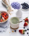 Matcha tea and muesli with almond yogurt and fresh berries — Stock Photo