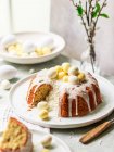 Coconut Easter cake with white chocolate eggs, sliced — Stock Photo