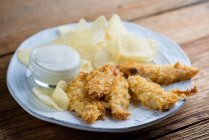 Fried chicken fingers with chips — Stock Photo