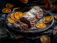 Insta Chocolate log with hints of orange orange peel with icing sugar dusting — Stock Photo