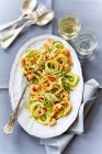 Pasta with chicken and vegetables on white plate — Stock Photo