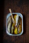 Sardines in a tin with a wooden fork — Stock Photo