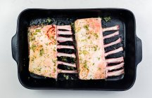 Close-up shot of delicious Raw rack of lamb in a roasting tray — Stock Photo