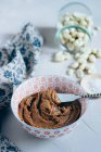 Homemade Peanut butter in ceramic bowl with metal spatula — Stock Photo