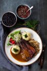 Pork steak with gingerbread sauce, potato dumplings and fried cabbage — Stock Photo