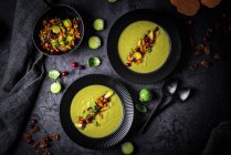 Roasted Brussels sprouts soup with pecan nuts, sweet potatoes and cranberries — Stock Photo