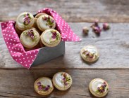 Spiced vegan sesame seed biscuits with white chocolate, pistachio nuts and rose petals — Stock Photo