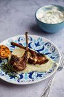 Roast lamb chops with garlic cream and Tzatziki — Stock Photo