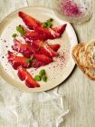 Beetroot salt cured salmon with bread slices — Stock Photo