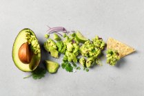 Transition from Avocado to Guacamole on a corn tortilla chip — Stock Photo