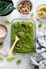 Pesto sauce with basil, spinach, garlic, parmesan, green peas, mint, gray background, top — Stock Photo