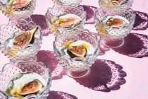Yogurt with figs and honey in crystal glasses — Stock Photo