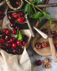Cherries in wooden crate and plate with mint — Stock Photo