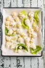 Fresh baked cauliflower and parsley on a white plate, top view — Stock Photo
