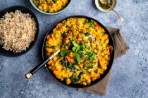 Vegan dal with red lentils, squash, chickpeas and spinach in bowl with rice — Stock Photo