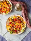 Plant based hot salad bowl with chickpeas, bell peppers, tomatoes, red chicory and turmeric — Stock Photo
